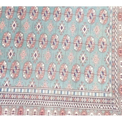 1148 - A Turkoman rug with multiple guls on a green ground 178x128cm