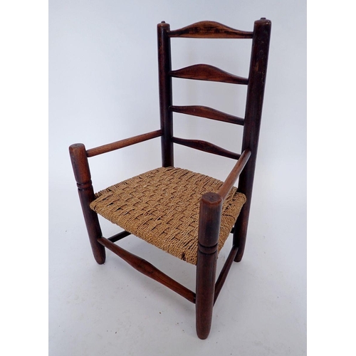 1164 - A child's country slat back elm chair with string seat