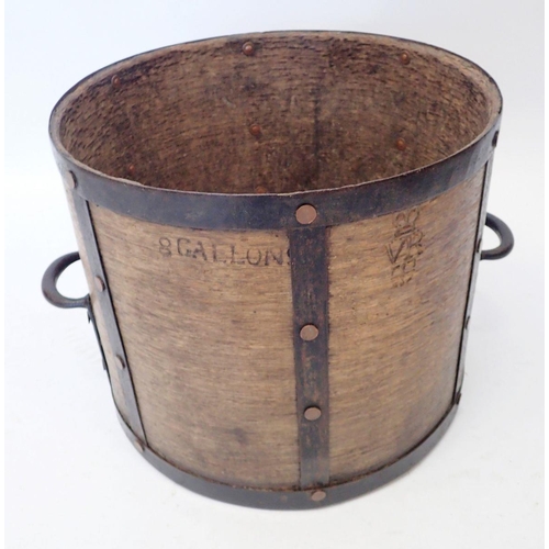 1179 - A Victorian wood and metal bound grain measure, stamped '8 Gallon VR Gloucester' 33cm tall