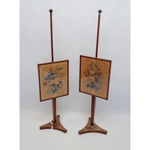 1183 - A pair of George III mahogany pole screens on triangular bases with ball finials and floral painted ... 