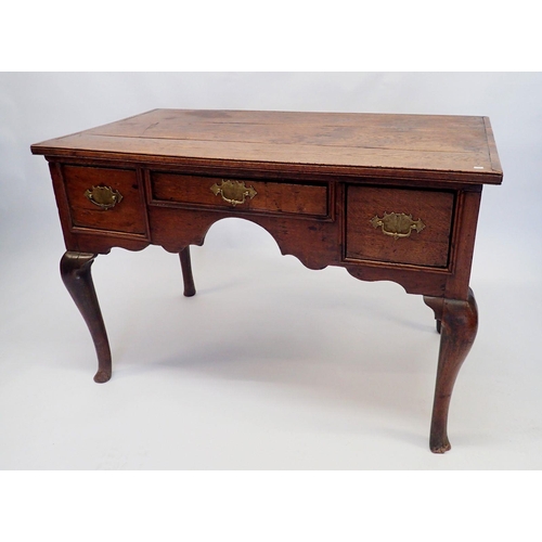 1194 - An 18th century oak lowboy with three frieze drawers, shaped apron and cabriole supports, 104 x 57 x... 