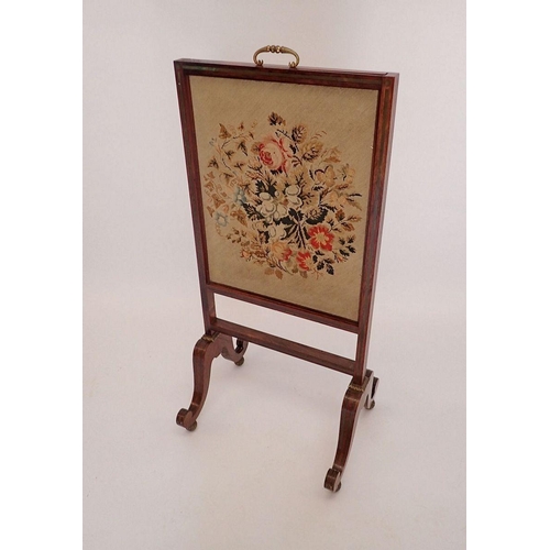 1197 - An early 19th century rosewood firescreen with vertical sliding tapestry panel, all on twin scroll s... 