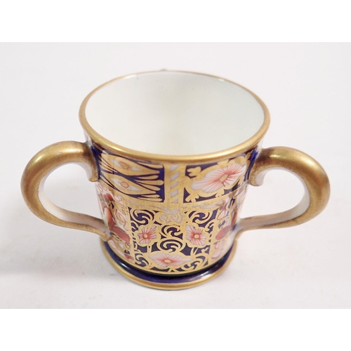 126 - A Royal Crown Derby miniature three handled tyg, 4cm tall