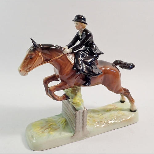 137 - A Beswick huntswoman riding side saddle, taking a fence