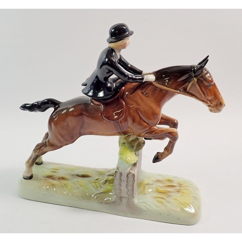 137 - A Beswick huntswoman riding side saddle, taking a fence