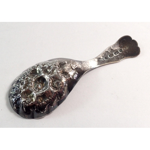 264 - A silver caddy spoon with floral embossed decoration by George Unite, Birmingham 1871