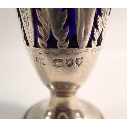 310 - A Victorian silver circular form pepper pot with pierced leaf panels and blue glass liner, London 18... 