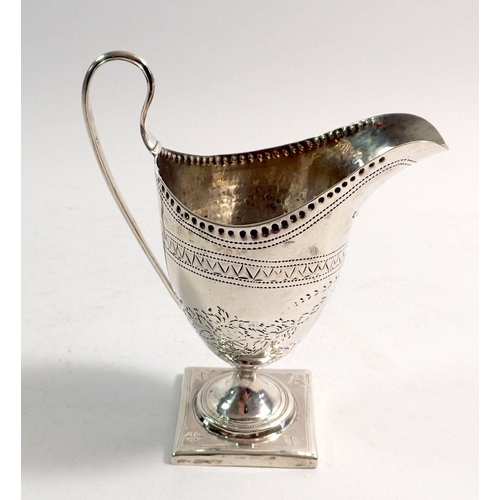 321 - A Georgian helmet-shaped silver cream jug with swagged floral decoration and initial to central shie... 