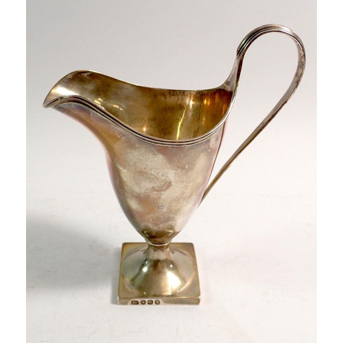 323 - A George III silver cream jug of helmet form on square base, London 1802, 102g