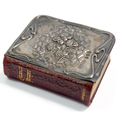 343 - A miniature leather prayer book with embossed silver front decorated winged angels, Birmingham 1905