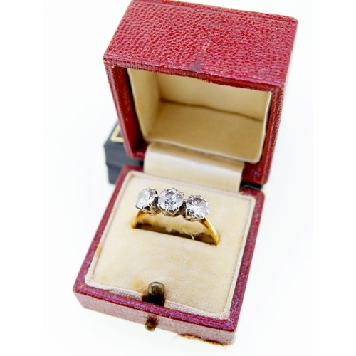 377 - An antique 18 carat gold three stone diamond ring, the central stone approx 0.5 carats, size T, 3.2g