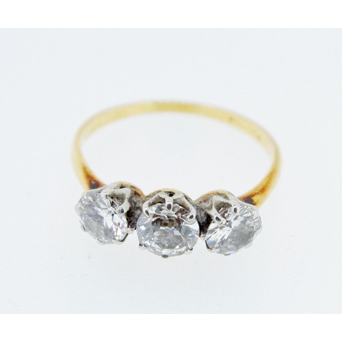 377 - An antique 18 carat gold three stone diamond ring, the central stone approx 0.5 carats, size T, 3.2g