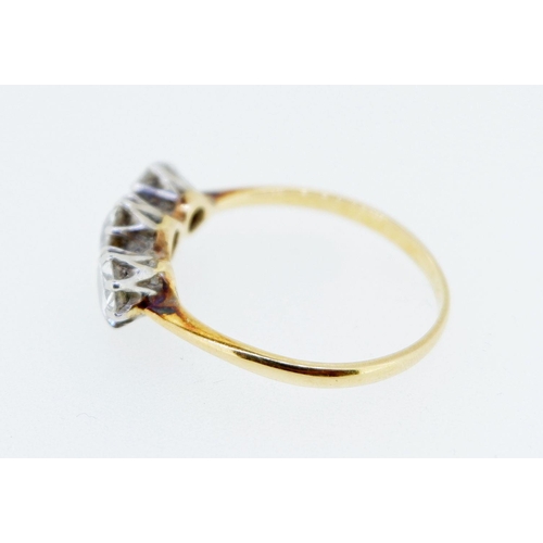 377 - An antique 18 carat gold three stone diamond ring, the central stone approx 0.5 carats, size T, 3.2g