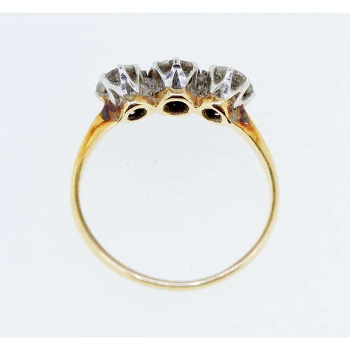 377 - An antique 18 carat gold three stone diamond ring, the central stone approx 0.5 carats, size T, 3.2g