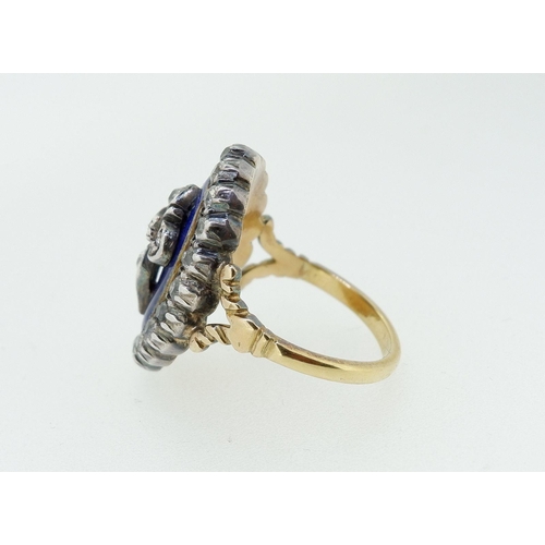 378 - An antique 18 carat gold and enamel ring silver set with old cut diamonds, the central Fleur De Lys ... 