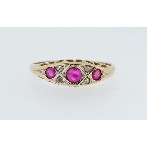 393 - A 9 carat gold ruby three stone ring inset diamonds, 2g, size N