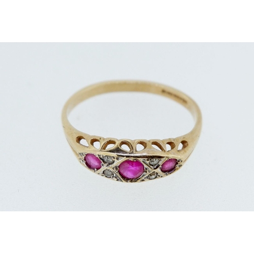 393 - A 9 carat gold ruby three stone ring inset diamonds, 2g, size N