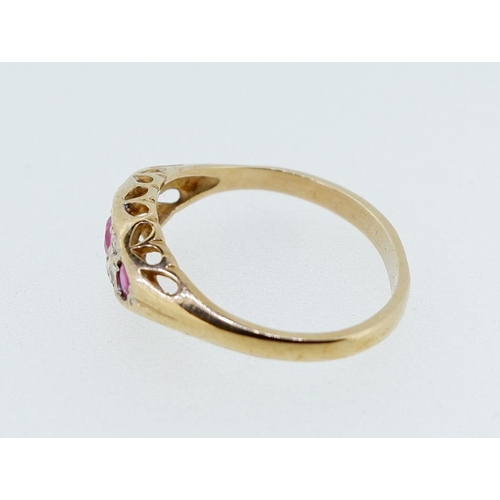 393 - A 9 carat gold ruby three stone ring inset diamonds, 2g, size N