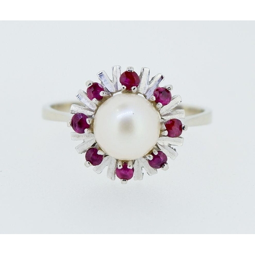 399 - A vintage 14k white gold ring set pearl within star and red stone surround, 2.8g, size P to Q