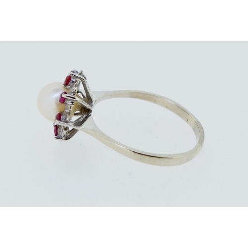 399 - A vintage 14k white gold ring set pearl within star and red stone surround, 2.8g, size P to Q