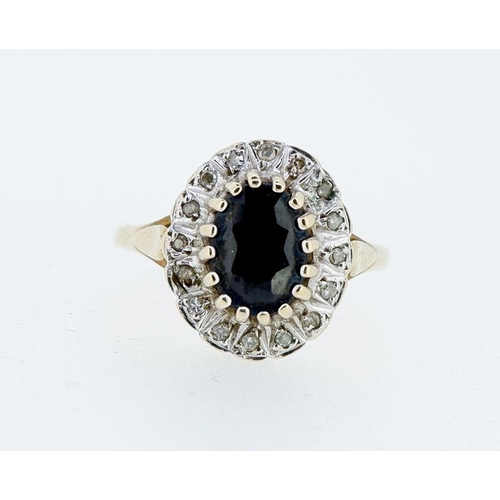 409 - A 9 carat gold oval sapphire ring with white stone surround, 2.7g, size N