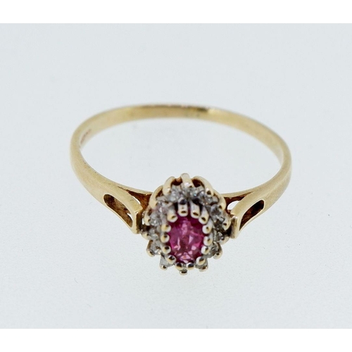 413 - A 9 carat gold oval cluster ring set ruby and diamonds, size O-P, 1.7g