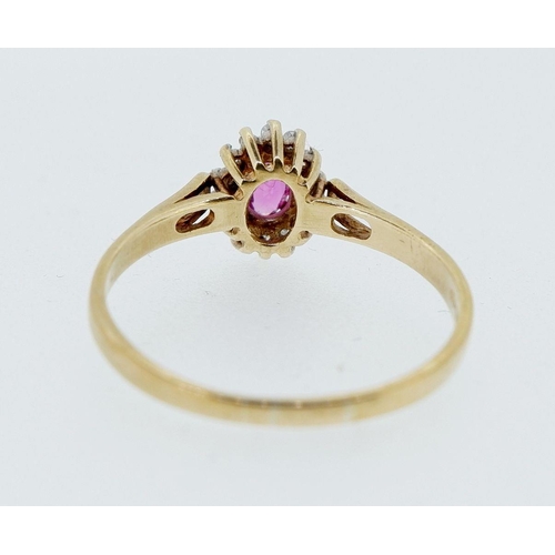 413 - A 9 carat gold oval cluster ring set ruby and diamonds, size O-P, 1.7g