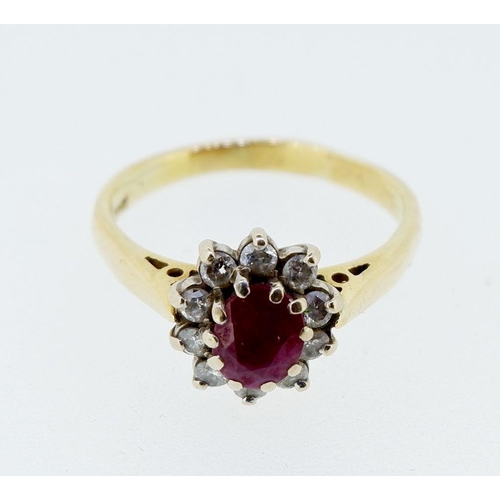 414 - An 18 carat gold ruby and diamond cluster ring, size N, 3.9g