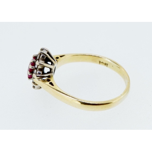 414 - An 18 carat gold ruby and diamond cluster ring, size N, 3.9g