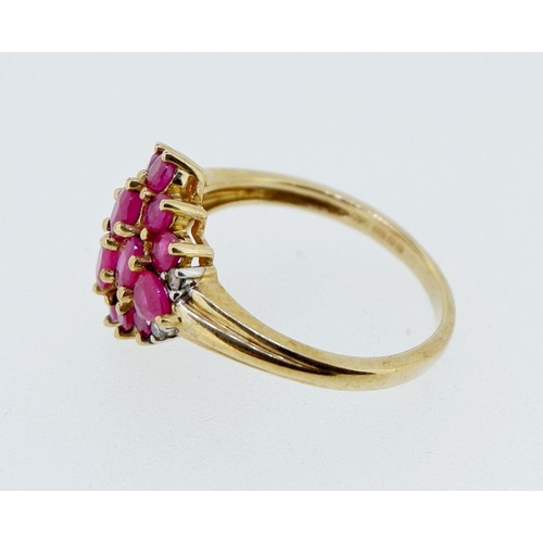 416 - A 9 carat gold ruby cluster ring with chip diamonds to shoulders, 3.4g, size P to Q