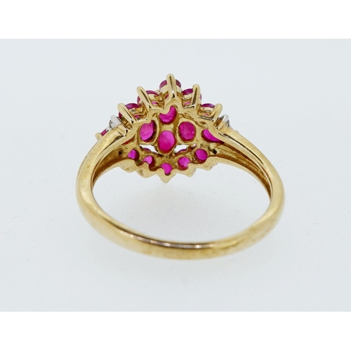 416 - A 9 carat gold ruby cluster ring with chip diamonds to shoulders, 3.4g, size P to Q