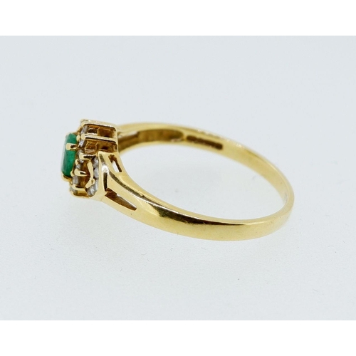 419 - An 18 carat gold ring set emerald within diamond surround and on diamond set shoulders, 3g, size P