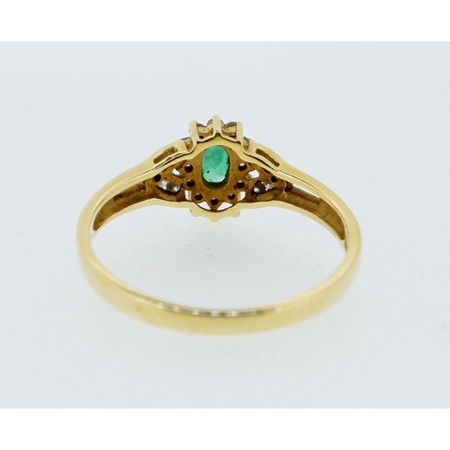 419 - An 18 carat gold ring set emerald within diamond surround and on diamond set shoulders, 3g, size P