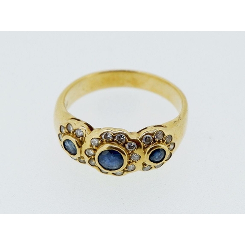 424 - An 18 carat gold ring set triple sapphire and diamond cluster, size N, 4.4g