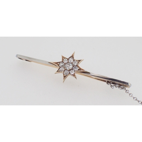 433 - An antique 18 carat and 15 carat white and yellow gold bar brooch with diamond set star and safety c... 