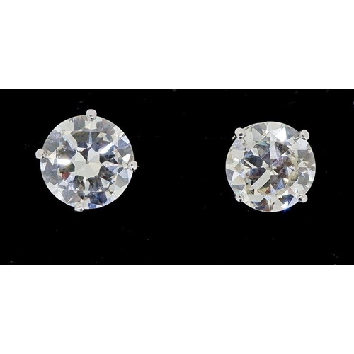 434 - A pair of large 18 carat white gold diamond stud earrings, total 5.2 carats with screw backs