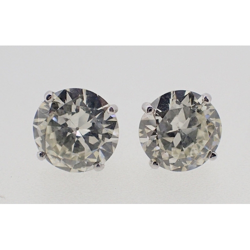 434 - A pair of large 18 carat white gold diamond stud earrings, total 5.2 carats with screw backs