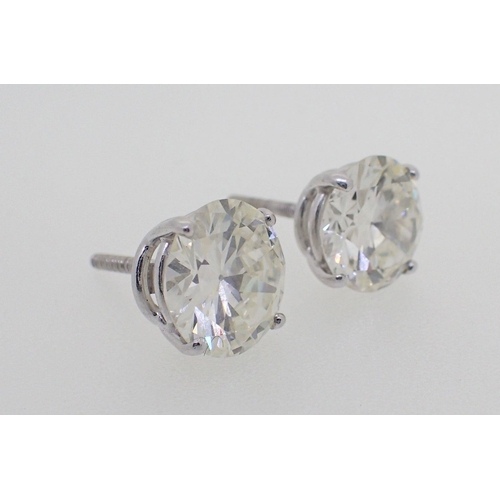 434 - A pair of large 18 carat white gold diamond stud earrings, total 5.2 carats with screw backs