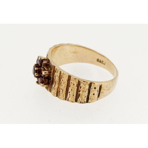 453 - A vintage 9 carat gold garnet cluster ring on textured band, size M to N, 3.7g