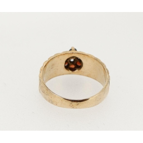 453 - A vintage 9 carat gold garnet cluster ring on textured band, size M to N, 3.7g