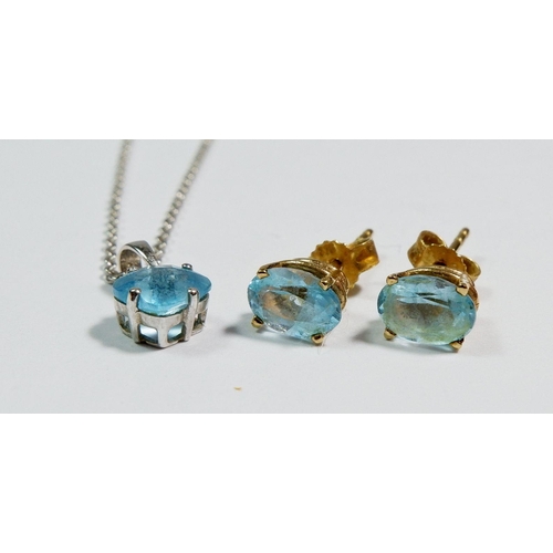 489 - An 18 carat white gold pendant necklace with blue topaz drop and a pair of yellow metal stud earring... 