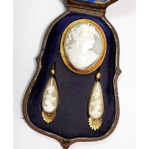 497 - A Victorian 15 carat gold Etruscan style shell cameo brooch and pair of pendant earrings, all in ori... 