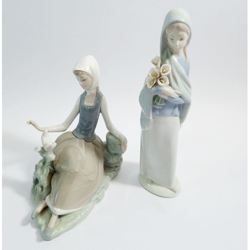 50 - Two Lladro figures of ladies with bird and flowers, 23cm tall