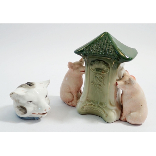 51 - A Victorian porcelain pigs head money box, (chipped ears) and a novelty pig spill vase, 10.5cm tall