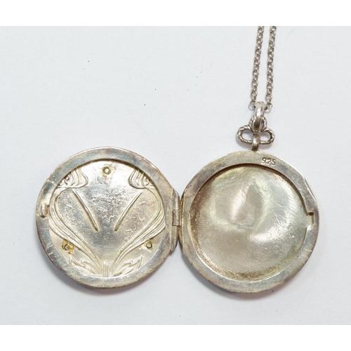 520 - An Art Nouveau silver circular circular locket with enamel iris decoration, marked AM Ltd, on silver... 