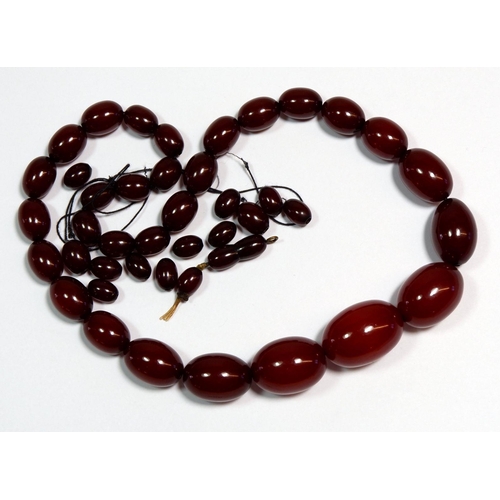 560 - A cherry amber bead necklace, 75g