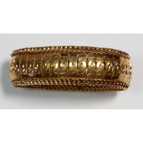 569 - A rolled gold reticulated bangle