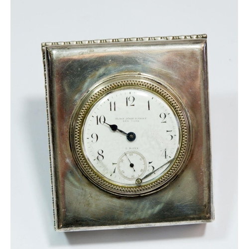 619 - An American sterling silver eight day easel clock with hinged ring support, retailed by Black, Starr... 