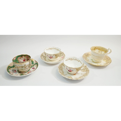 71 - A group of four Victorian cups and saucers with floral decoration