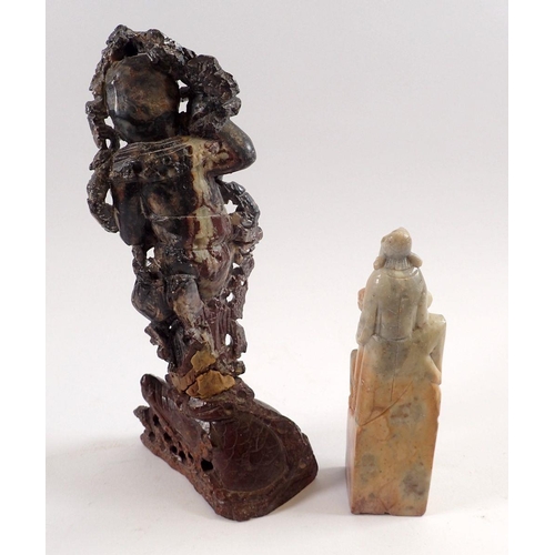 749 - A Chinese soapstone figure of a deity, 21cm tall and a carved stone seal of scholars, 13.5cm tall